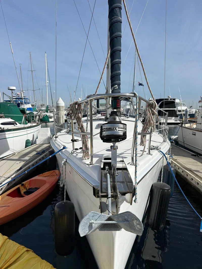 Slide: The Image of 2008 Hunter 38 sailboat docked at marina, front view with anchor and rigging. - 4