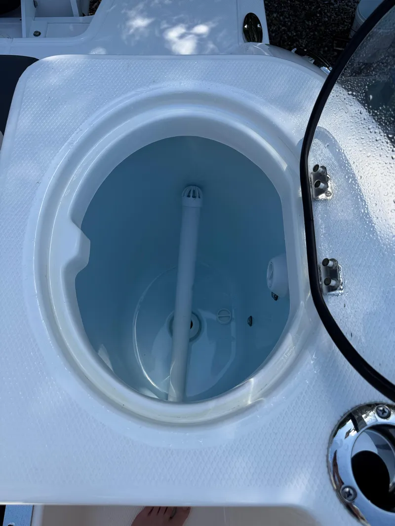 Slide: The Image of 2024 Robalo R317 boat livewell with open lid, showcasing interior design. - 10