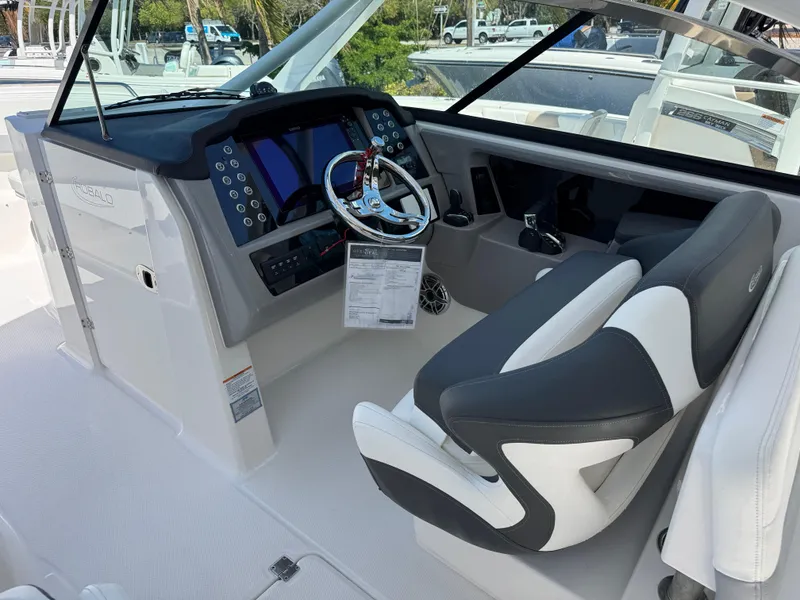 Slide: The Image of 2024 Robalo R317 boat cockpit with modern controls and comfortable seating. - 17