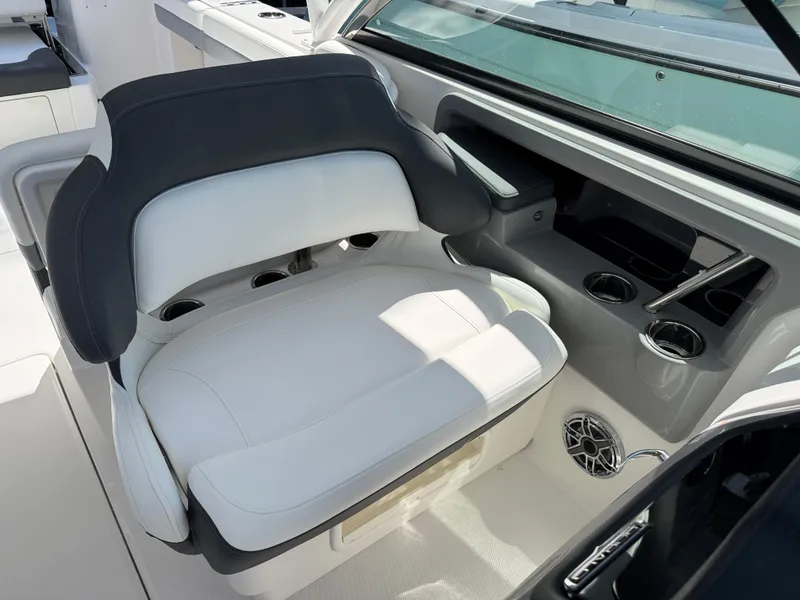Slide: The Image of 2024 Robalo R317 boat interior with luxurious seating and cup holders. - 18