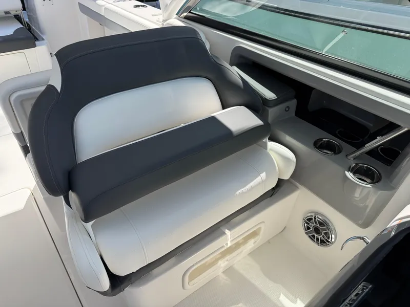 Slide: The Image of 2024 Robalo R317 boat interior with cushioned seating and cup holders. - 19