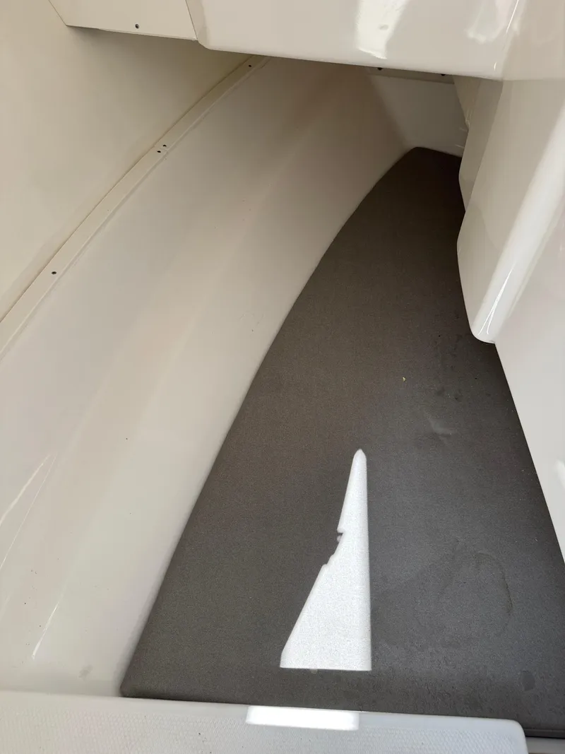 Slide: The Image of 2024 Robalo R317 interior cabin with sleek, modern design and comfortable flooring. - 21