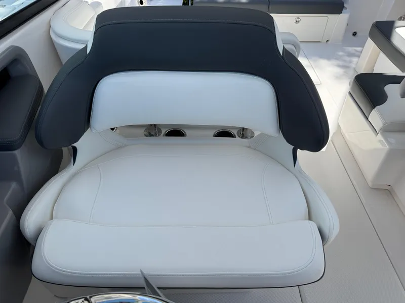 Slide: The Image of 2024 Robalo R317 boat seat with white and black upholstery. - 24