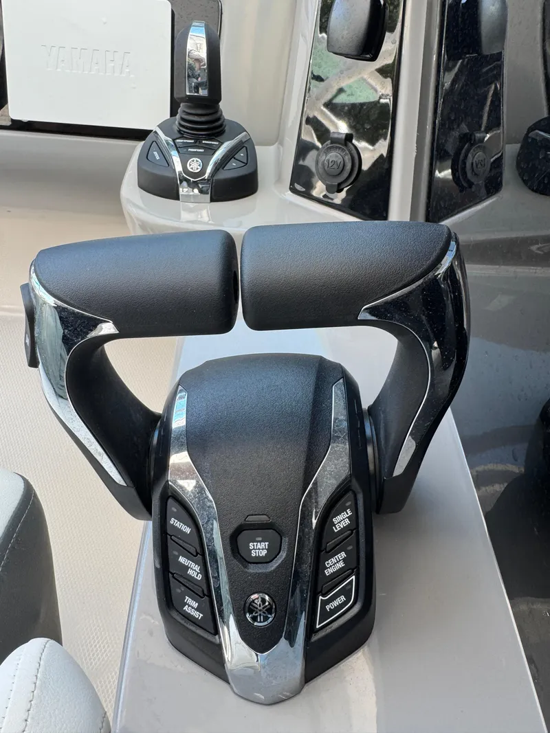 Slide: The Image of 2024 Robalo R317 boat throttle controls with sleek design and advanced features. - 25