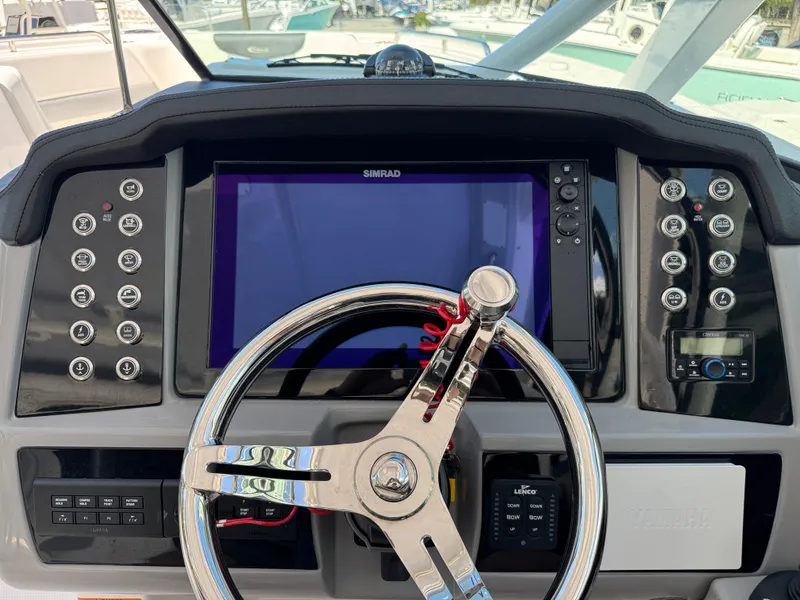 Slide: The Image of 2024 Robalo R317 helm with Simrad display and modern controls. - 30