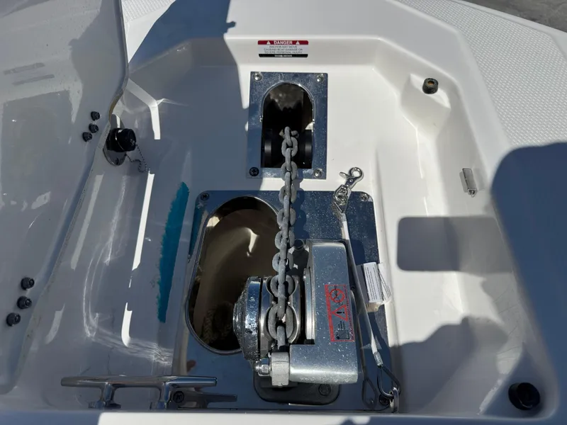 Slide: The Image of 2024 Robalo R317 boat anchor chain and winch system in open compartment. - 36