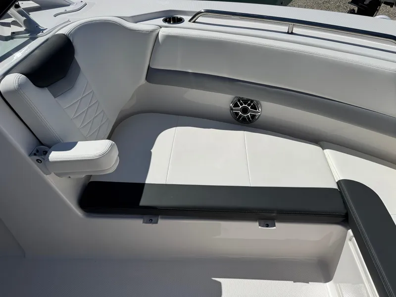 Slide: The Image of 2024 Robalo R317 boat interior with white seating and speaker detail. - 38