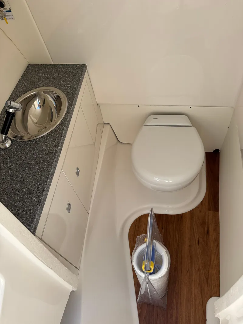 Slide: The Image of 2024 Robalo R317 boat bathroom with sink, toilet, and wood flooring. - 40