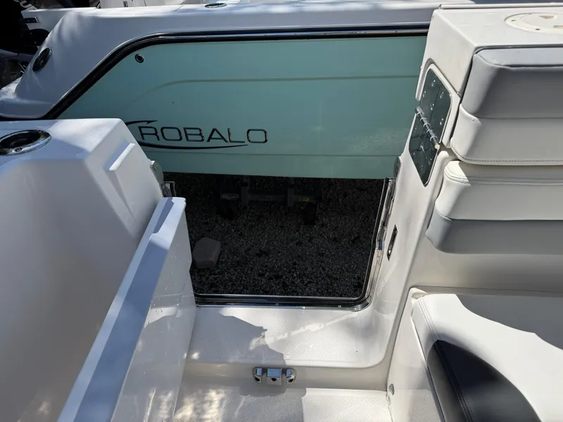 Slide: The Image of 2024 Robalo R317 boat interior with open door and seating area. - 47