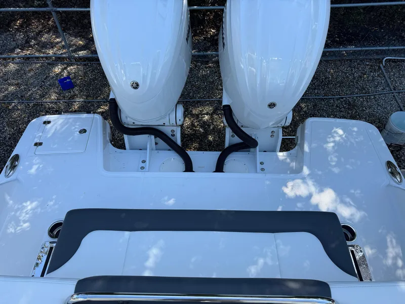 Slide: The Image of 2024 Robalo R317 boat with dual outboard engines, rear deck view. - 48