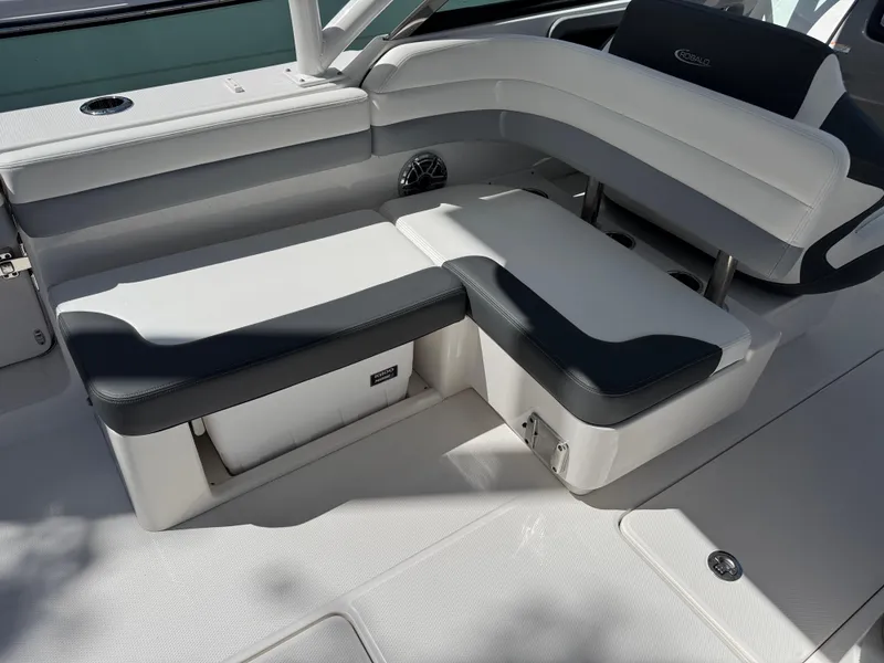 Slide: The Image of 2024 Robalo R317 boat seating area with white and black cushioned seats. - 8