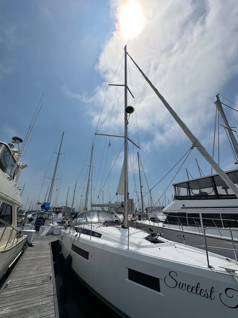 Slide: The Image of Jeanneau Sun Odyssey 410 sailboat docked under a bright sun, 2020 model. - 10