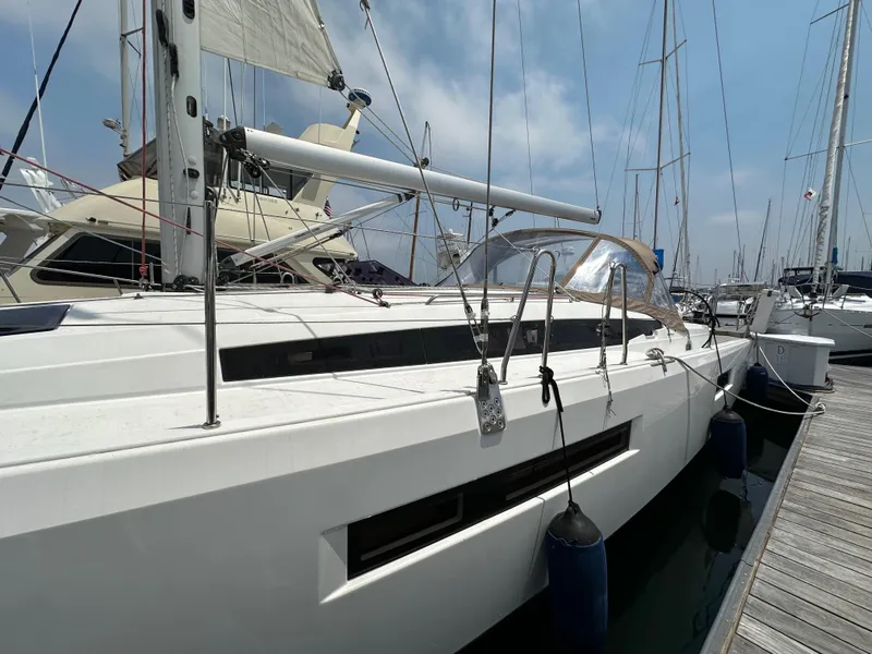 Slide: The Image of 2020 Jeanneau Sun Odyssey 410 sailboat docked at marina under clear sky. - 17
