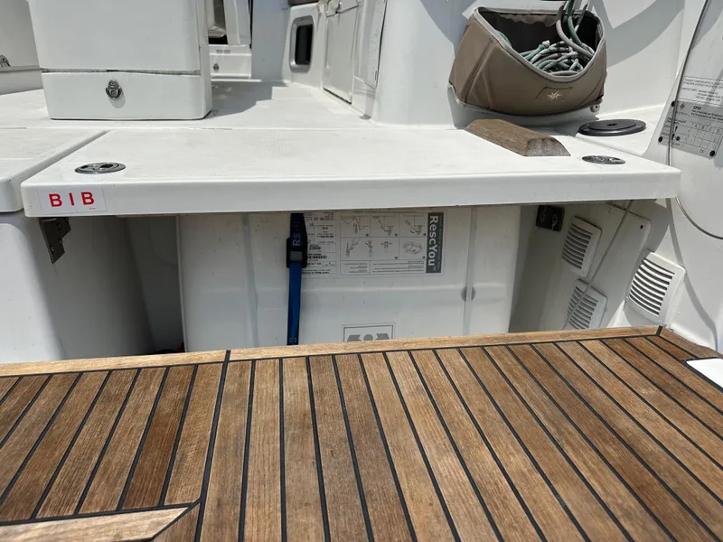 Slide: The Image of Jeanneau Sun Odyssey 410, 2020 model, featuring a teak deck and cockpit storage area. - 19