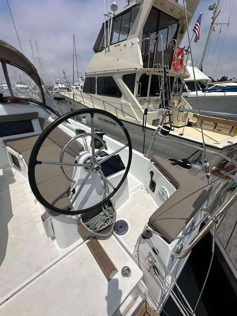 Slide: The Image of 2020 Jeanneau Sun Odyssey 410 sailboat with steering wheel, docked at marina. - 22