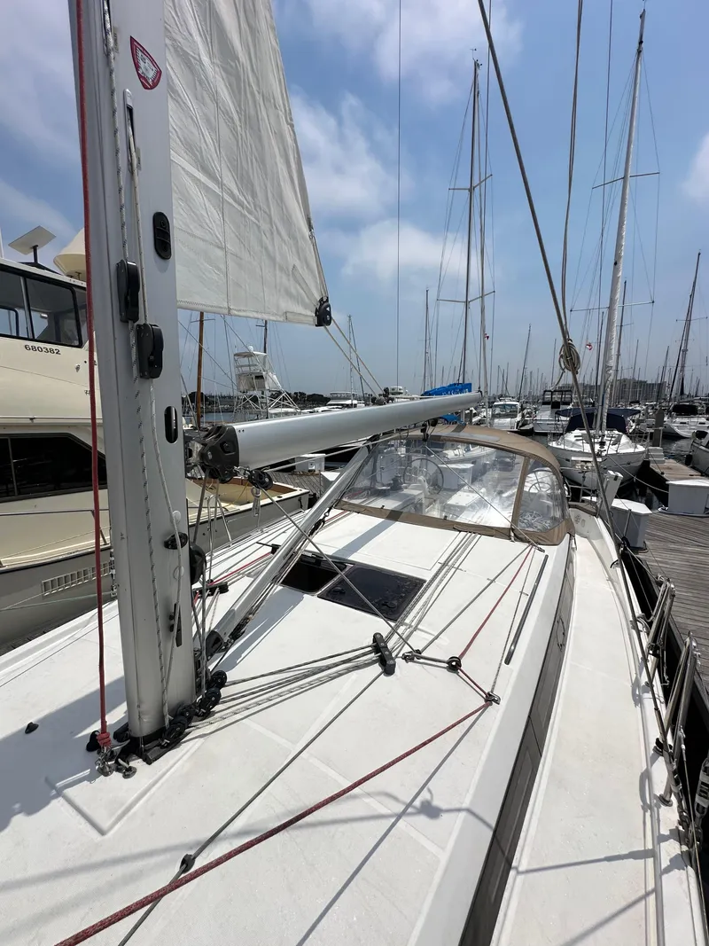 Slide: The Image of 2020 Jeanneau Sun Odyssey 410 sailboat docked at marina, showcasing deck and rigging. - 36
