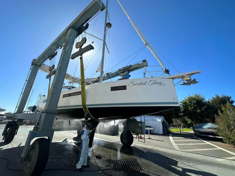 Slide: The Image of 2020 Jeanneau Sun Odyssey 410 sailboat being lifted by a crane in a boatyard. - 4