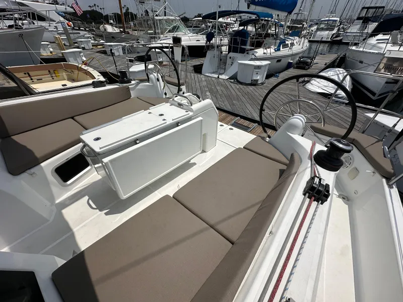 Slide: The Image of 2020 Jeanneau Sun Odyssey 410 yacht cockpit with dual steering wheels and cushioned seating. - 40