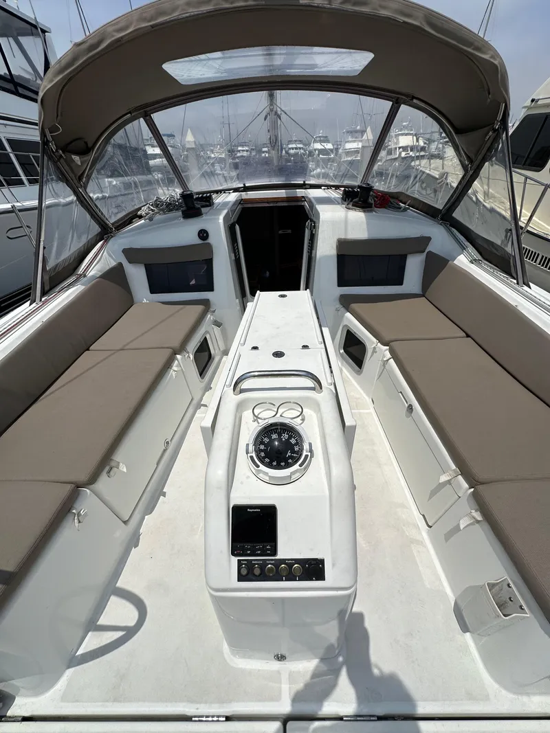 Slide: The Image of 2020 Jeanneau Sun Odyssey 410 cockpit with beige seating and navigation controls. - 46