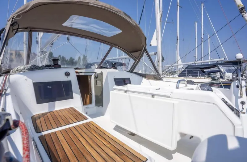 Slide: The Image of 2020 Jeanneau Sun Odyssey 410 sailboat cockpit with wooden flooring and canopy. - 47