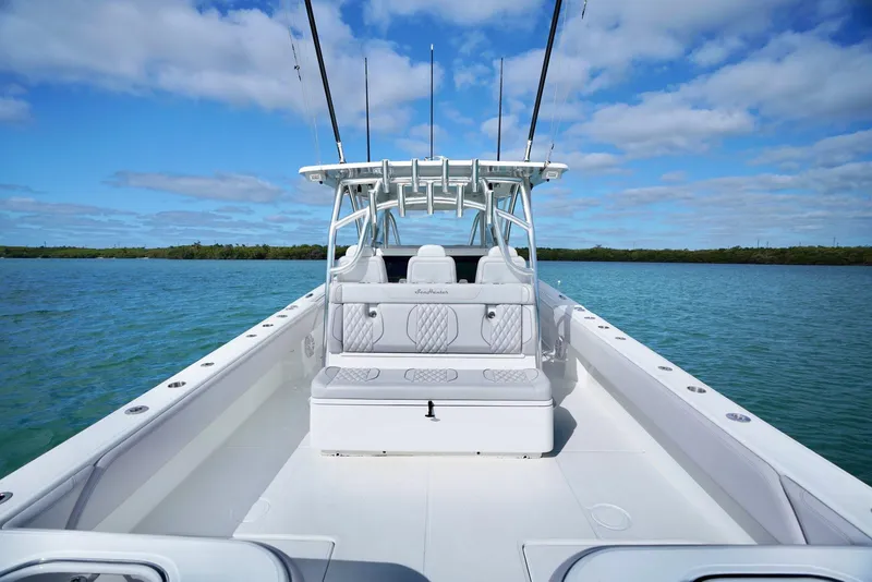 Slide: The Image of 2023 SeaHunter 41 CTS boat on calm water under a clear blue sky. - 8