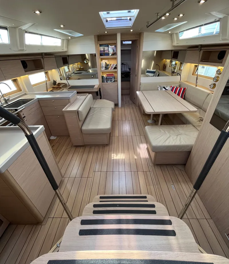 Slide: The Image of Spacious interior of 2019 Beneteau Oceanis 51.1 yacht with modern furnishings and wood finish. - 22
