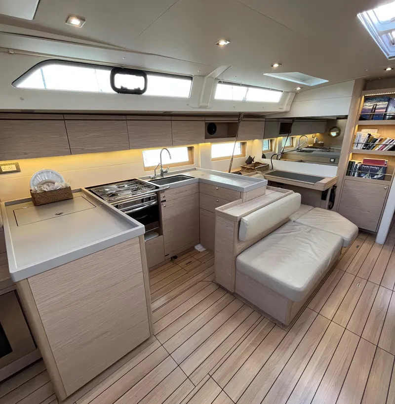 Slide: The Image of Luxurious interior of 2019 Beneteau Oceanis 51.1 yacht with modern kitchen and seating area. - 24