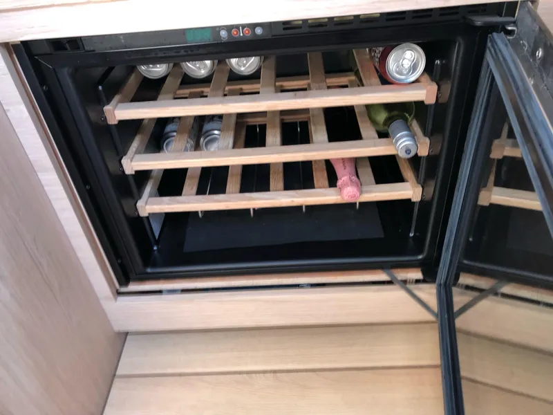 Slide: The Image of Wine cooler with wooden racks on a 2019 Beneteau Oceanis 51.1 yacht. - 26