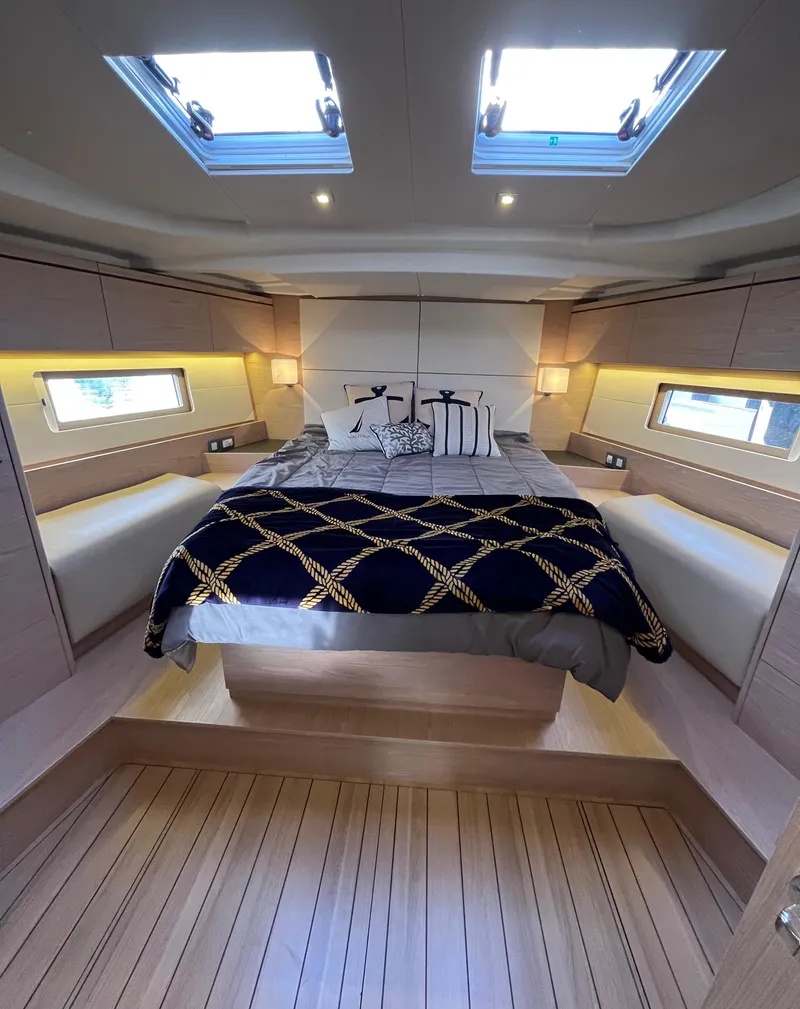 Slide: The Image of Luxurious cabin interior of 2019 Beneteau Oceanis 51.1 yacht with skylights and elegant bedding. - 30