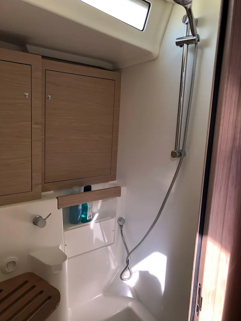 Slide: The Image of 2019 Beneteau Oceanis 51.1 yacht bathroom with shower and wooden cabinets. - 35