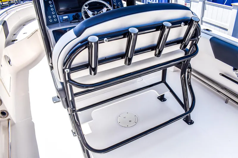 Slide: The Image of 2019 Robalo R242 Center Console boat interior with rod holders and steering console. - 4