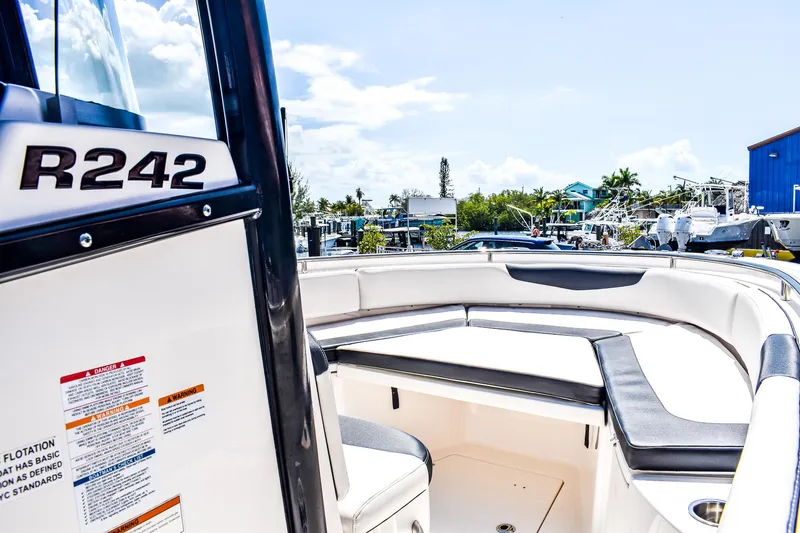 Slide: The Image of 2019 Robalo R242 Center Console boat, white interior, outdoor marina setting. - 8