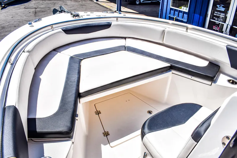 Slide: The Image of 2019 Robalo R242 Center Console boat interior with cushioned seating and storage. - 9