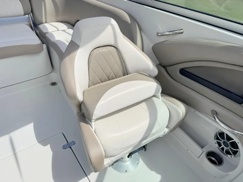 Slide: The Image of 2022 Crownline Eclipse E235 XS boat interior with beige seating and speaker. - 13
