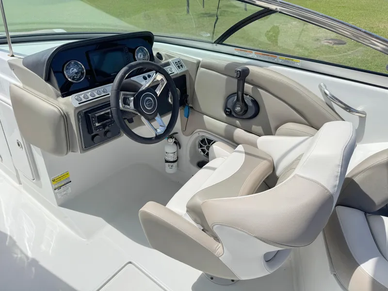 Slide: The Image of 2022 Crownline Eclipse E235 XS boat cockpit with steering wheel and control panel. - 14