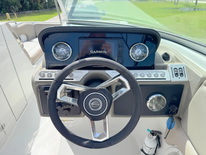 Slide: The Image of 2022 Crownline Eclipse E235 XS boat dashboard with Garmin display and steering wheel. - 15