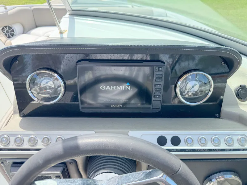 Slide: The Image of 2022 Crownline Eclipse E235 XS dashboard with Garmin display and controls. - 16