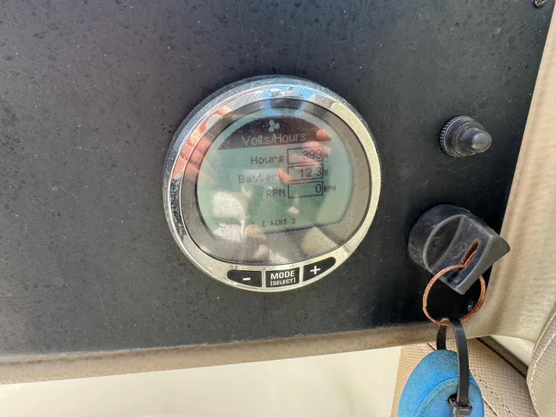 Slide: The Image of Dashboard of 2022 Crownline Eclipse E235 XS boat showing hour meter and controls. - 17