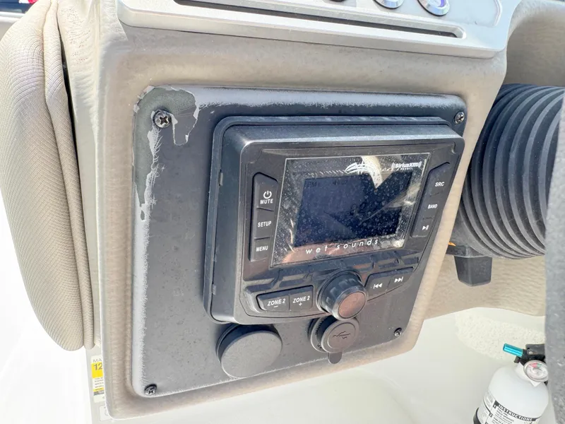 Slide: The Image of 2022 Crownline Eclipse E235 XS boat dashboard with audio control panel. - 18