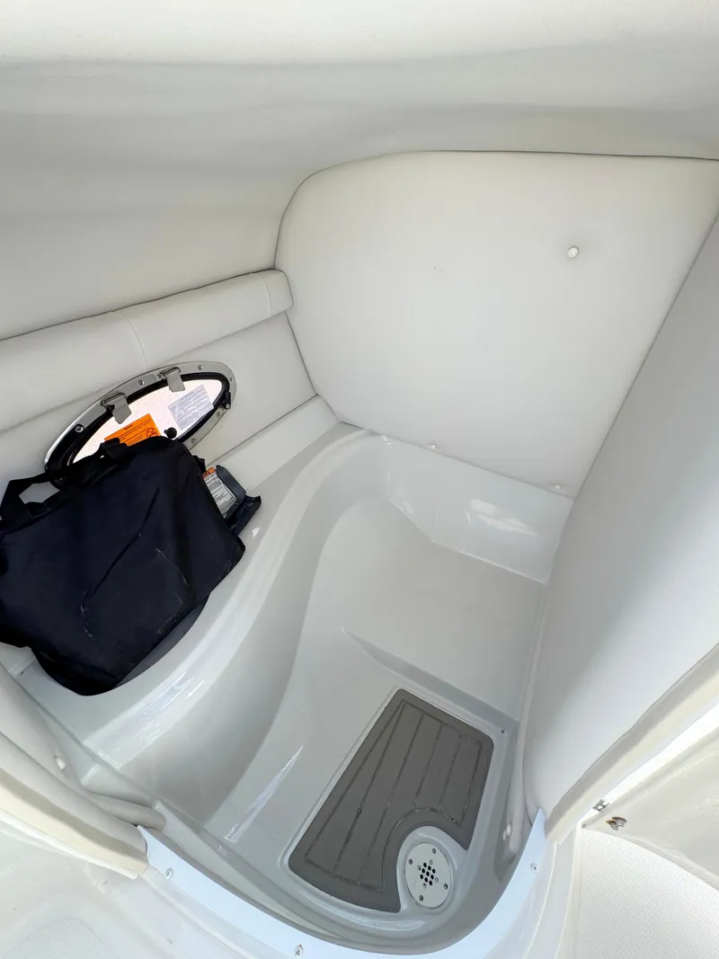 Slide: The Image of 2022 Crownline Eclipse E235 XS boat interior storage compartment with seating and drain. - 20