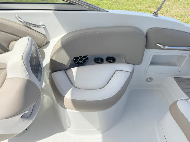 Slide: The Image of 2022 Crownline Eclipse E235 XS boat interior with beige seating and cup holders. - 22