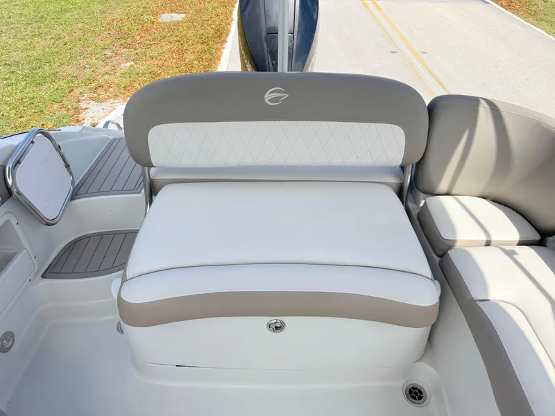 Slide: The Image of 2022 Crownline Eclipse E235 XS boat seating, featuring white and beige cushioned seats. - 23
