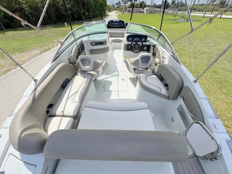 Slide: The Image of 2022 Crownline Eclipse E235 XS boat interior with spacious seating and modern dashboard. - 26