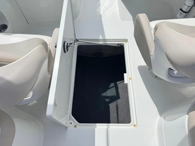 Slide: The Image of 2022 Crownline Eclipse E235 XS boat interior with open storage compartment. - 27