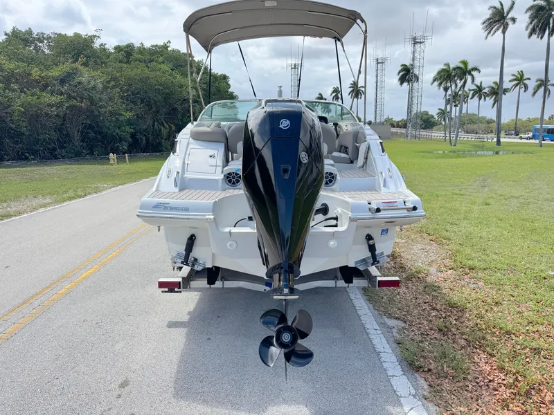 Slide: The Image of 2022 Crownline Eclipse E235 XS boat on road, rear view with outboard motor. - 3