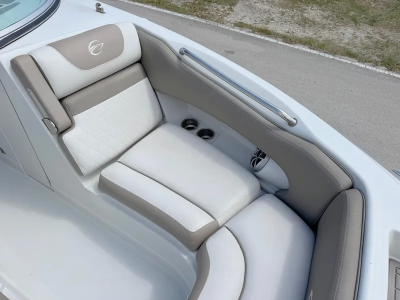 Slide: The Image of 2022 Crownline Eclipse E235 XS boat interior with beige and white cushioned seating. - 8