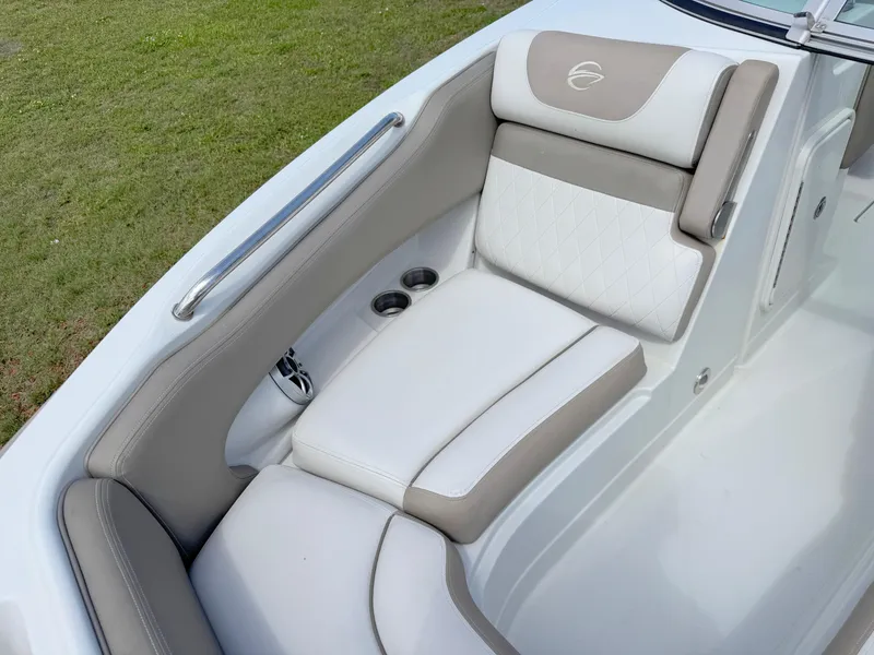 Slide: The Image of 2022 Crownline Eclipse E235 XS boat interior with beige and white cushioned seating. - 9