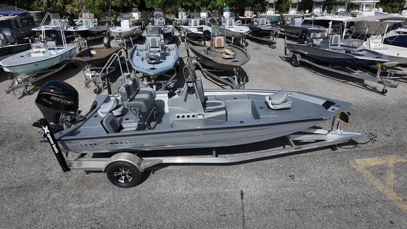 Slide: The Image of 2025 Xpress H20B boat on trailer in a marina with multiple boats. - 11