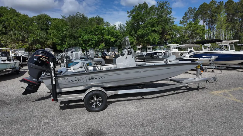 Slide: The Image of 2025 Xpress H20B boat on trailer in outdoor showroom. - 13