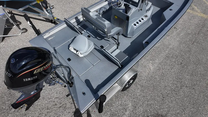 Slide: The Image of 2025 Xpress H20B boat with Yamaha engine, gray interior, and trailer. - 20